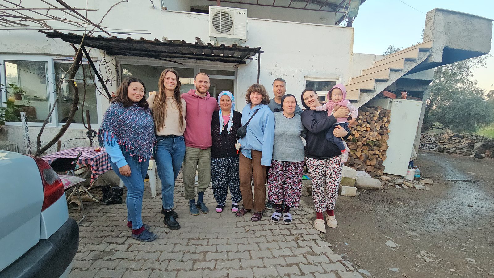 Hosts and guests gathered together outside the village house
