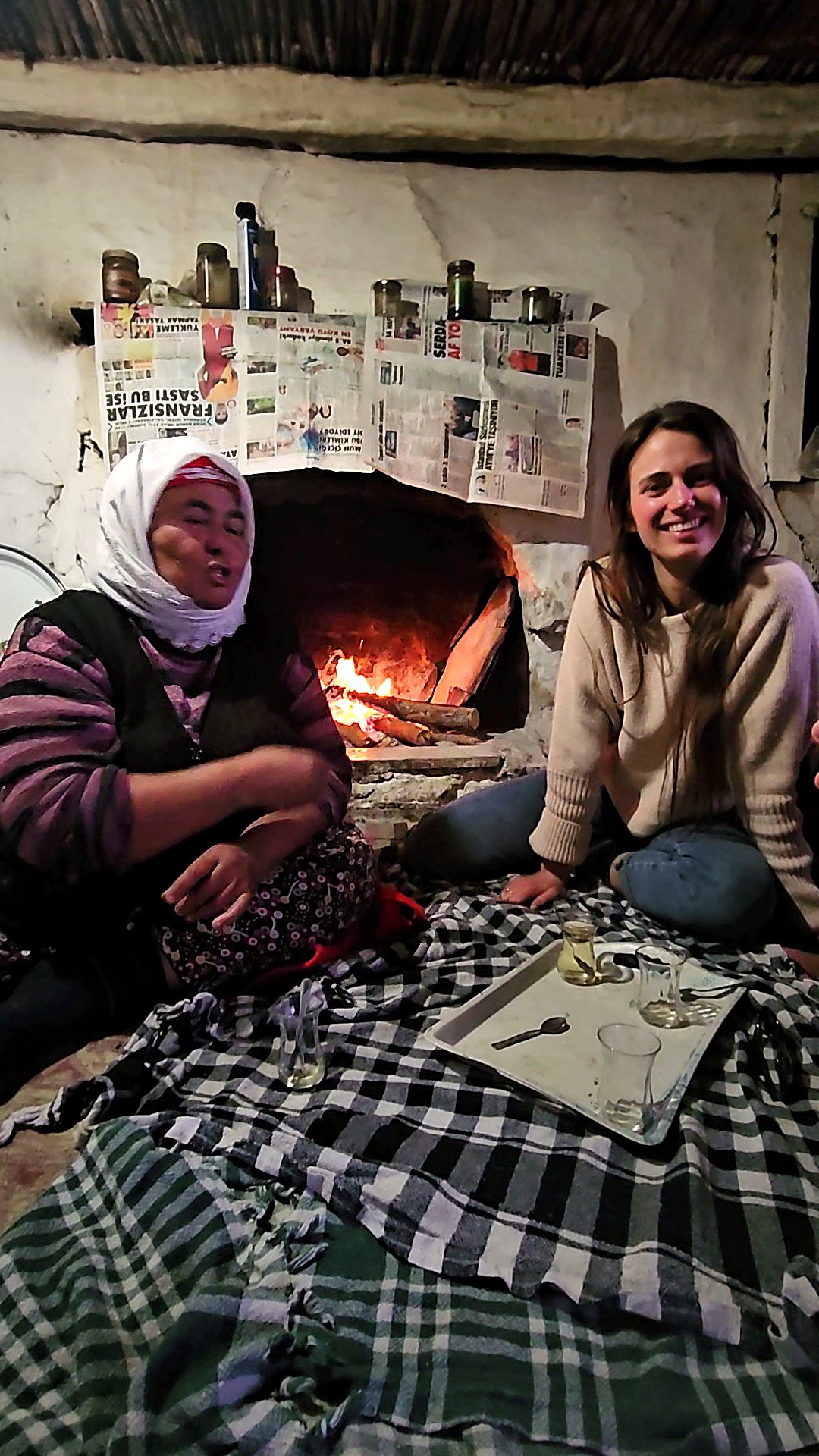 Sitting by the fireplace with tea, hosts and guests together