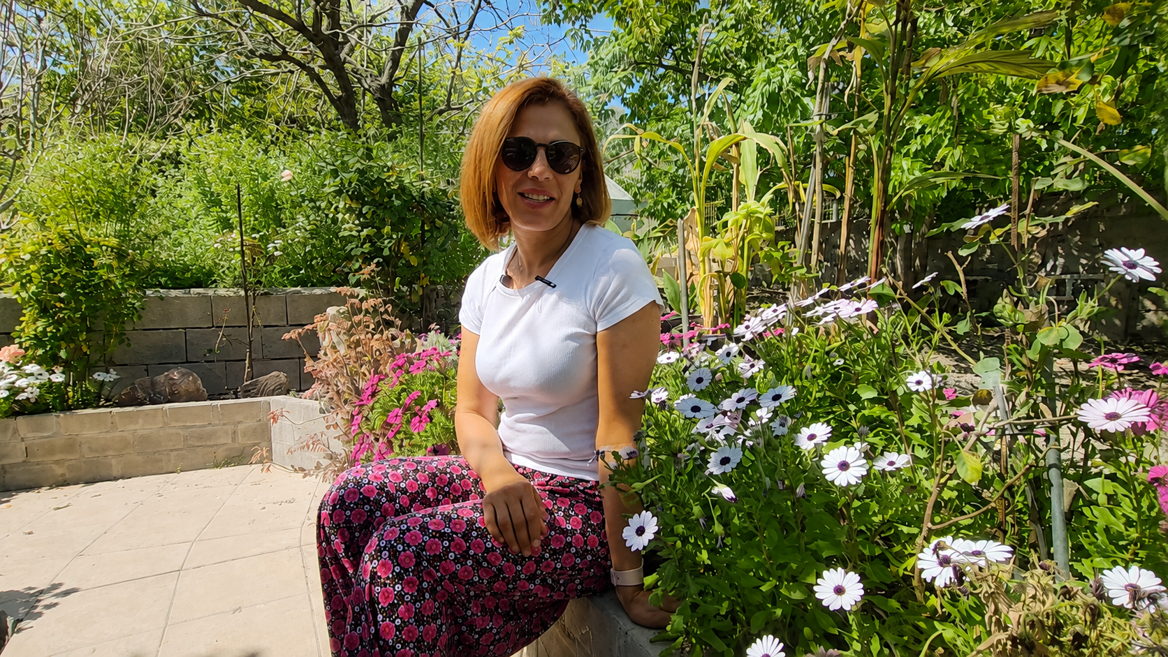 Cahide relaxing among the garden's flowers