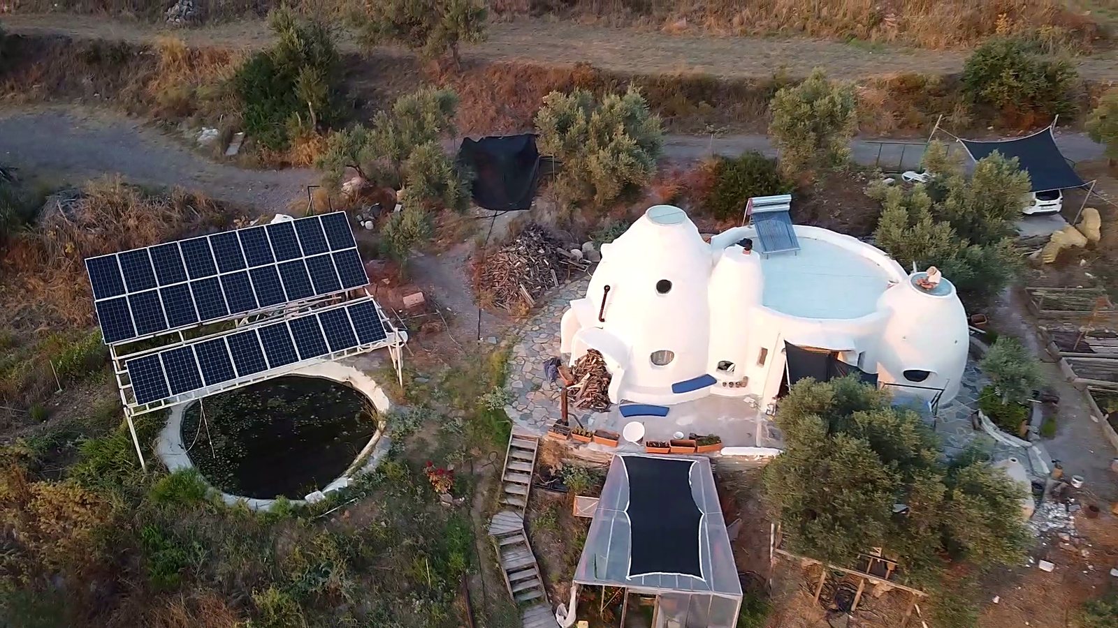 Aerial view of the superadobe domes, solar array and greenhouse